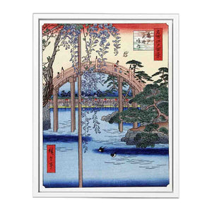 Footbridge over river with wisteria in foreground in full bloom